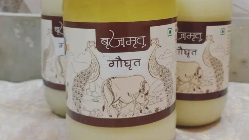 Three jars of ghee with a decorative label